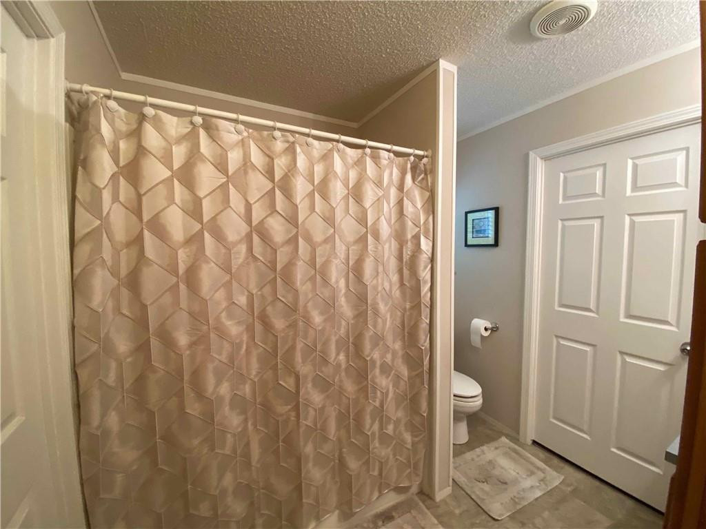 383 Gillis Road Roxboro, NC 27574 - Photo 14 of 19 a bathroom with a shower curtain and a shower curtain