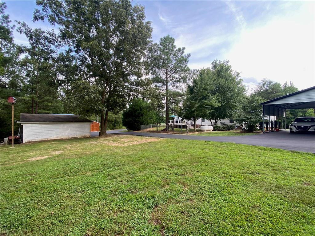 383 Gillis Road Roxboro, NC 27574 - Photo 16 of 19 a view of outdoor space with garden and trees