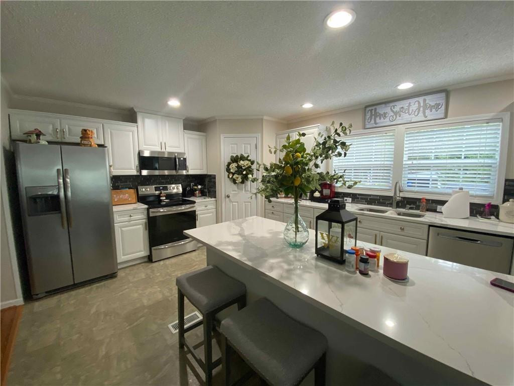 383 Gillis Road Roxboro, NC 27574 - Photo 6 of 19 a kitchen with stainless steel appliances granite countertop a sink counter space and chairs