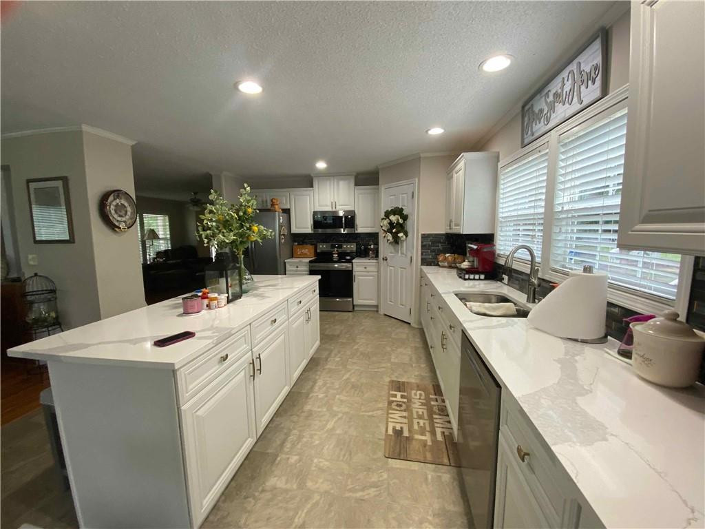 383 Gillis Road Roxboro, NC 27574 - Photo 7 of 19 a large white kitchen with sink stove and refrigerator