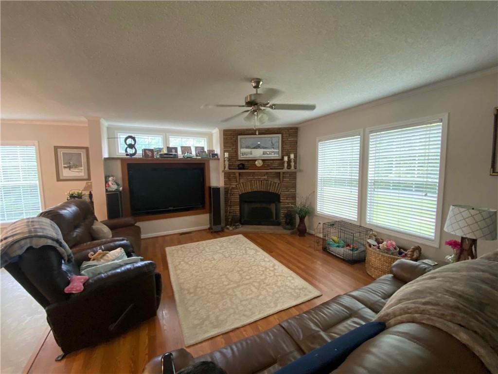 383 Gillis Road Roxboro, NC 27574 - Photo 8 of 19 a living room with furniture a flat screen tv and a fireplace