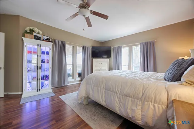 a bedroom with a large bed and a chandelier