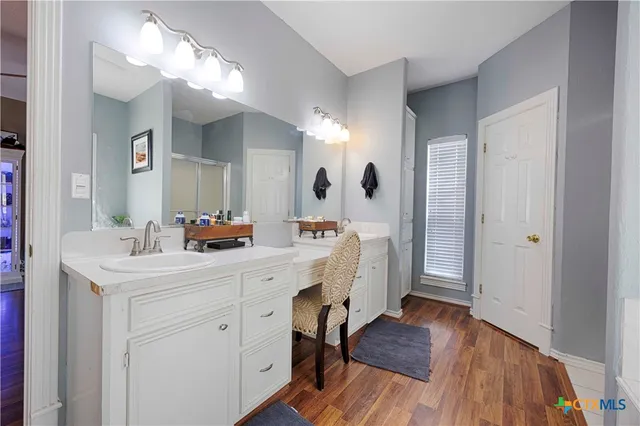 a bathroom with a tub sink and mirror