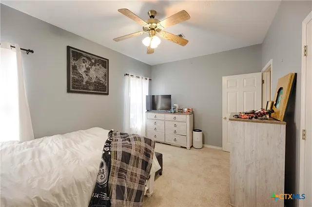 a bedroom with a bed and a window