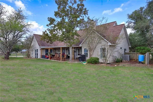 a front view of house with yard barbeque and green space