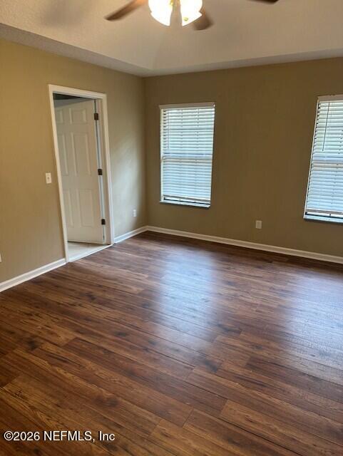 45035 Hartford Court Callahan, FL 32011 - Photo 11 of 30 an empty room with wooden floor cabinet and windows