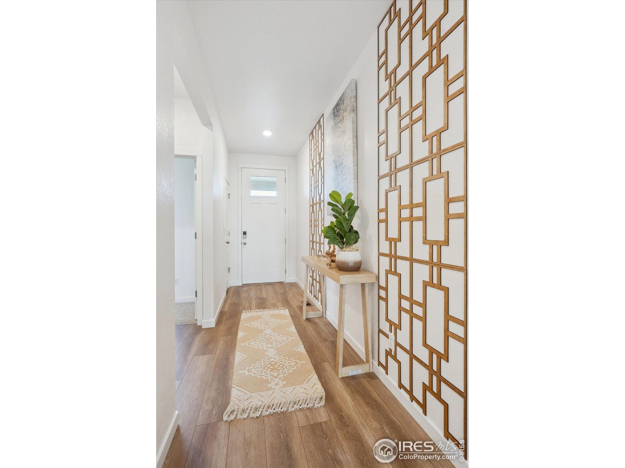 2303 Base Street Fort Lupton, CO 80621 - Photo 2 of 26 a view of a hallway and a dining room