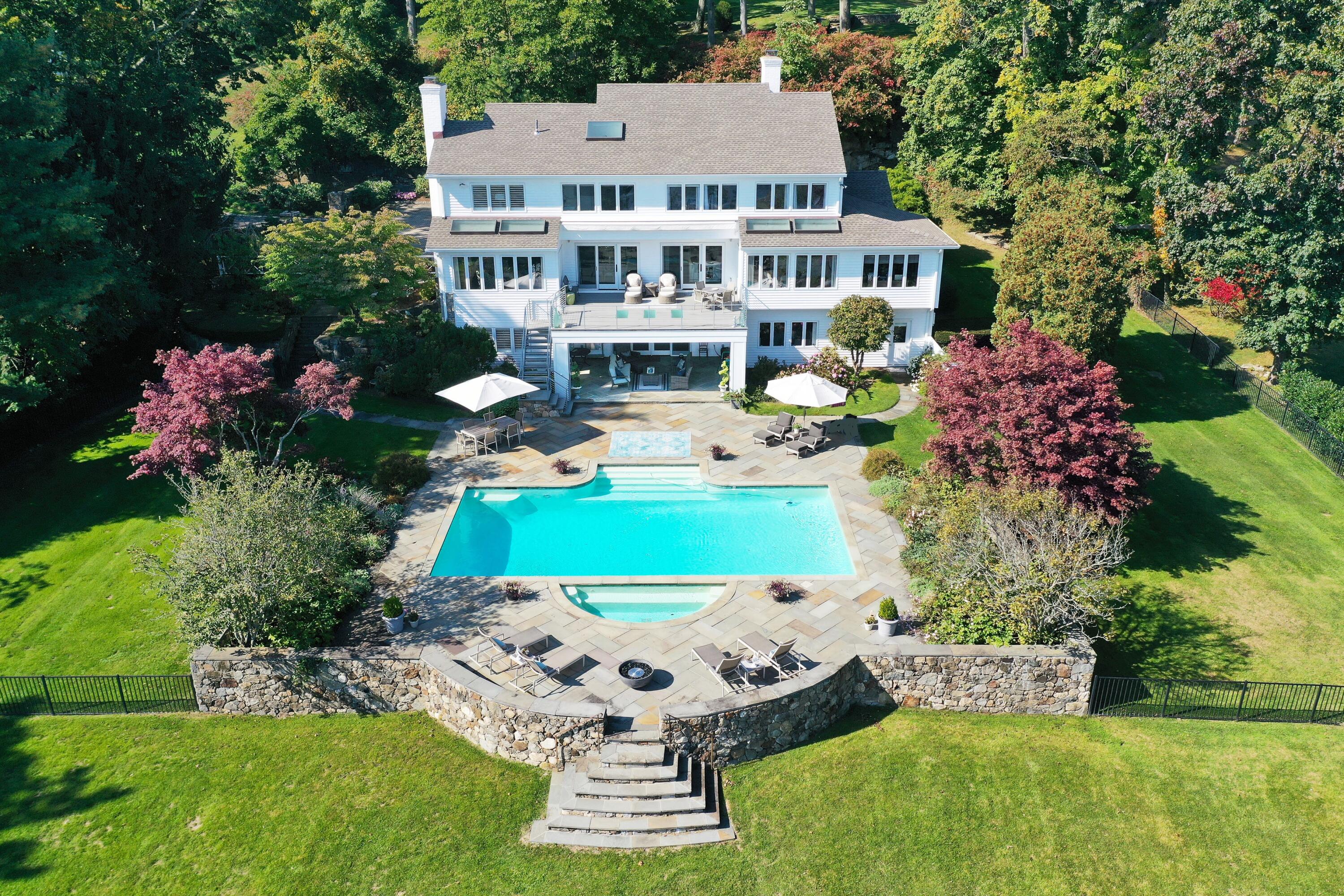 a view of a house with a yard balcony and sitting area