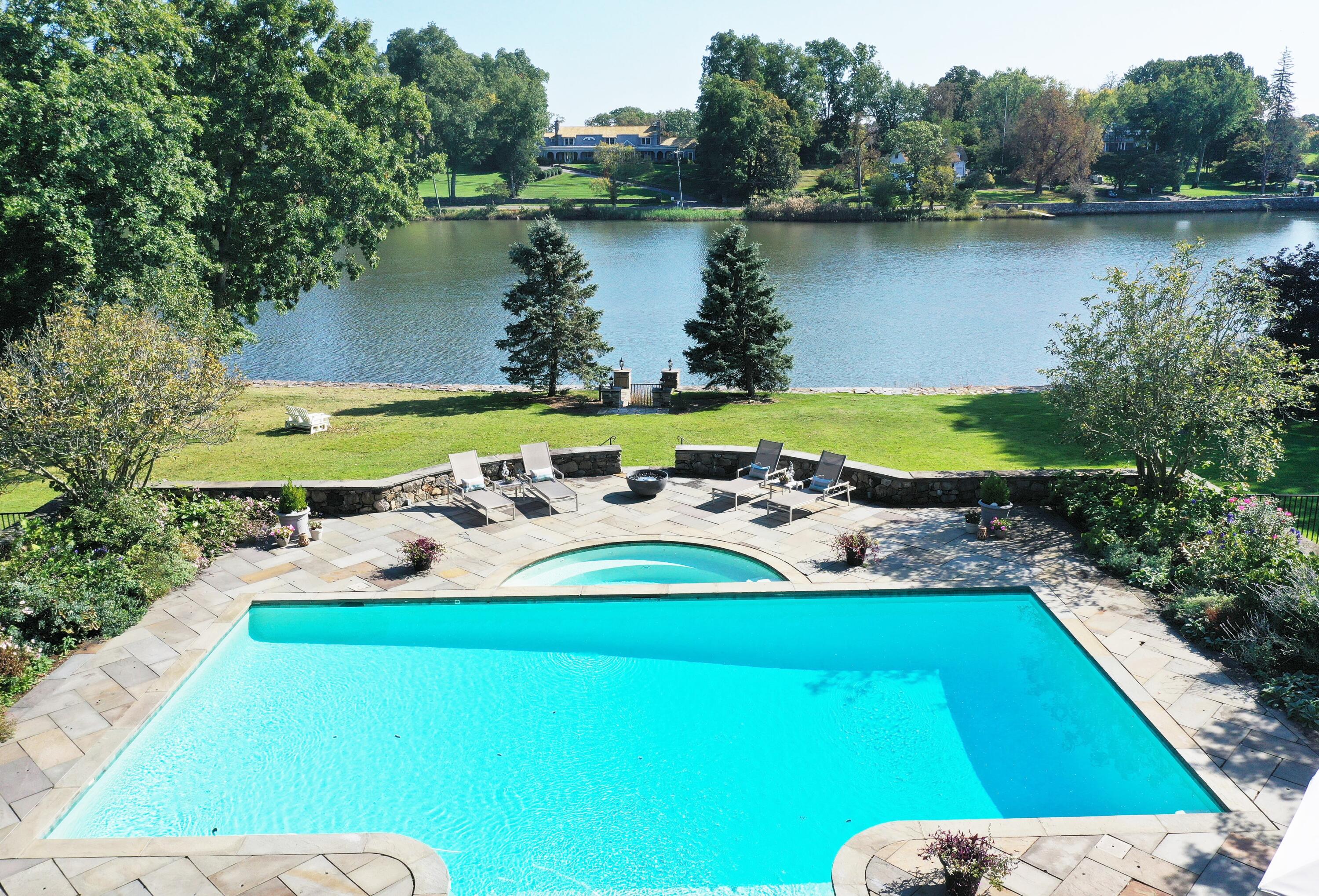 79 Rings End Road Darien, CT 06820 - Photo 2 of 42 a view of a lake with a house