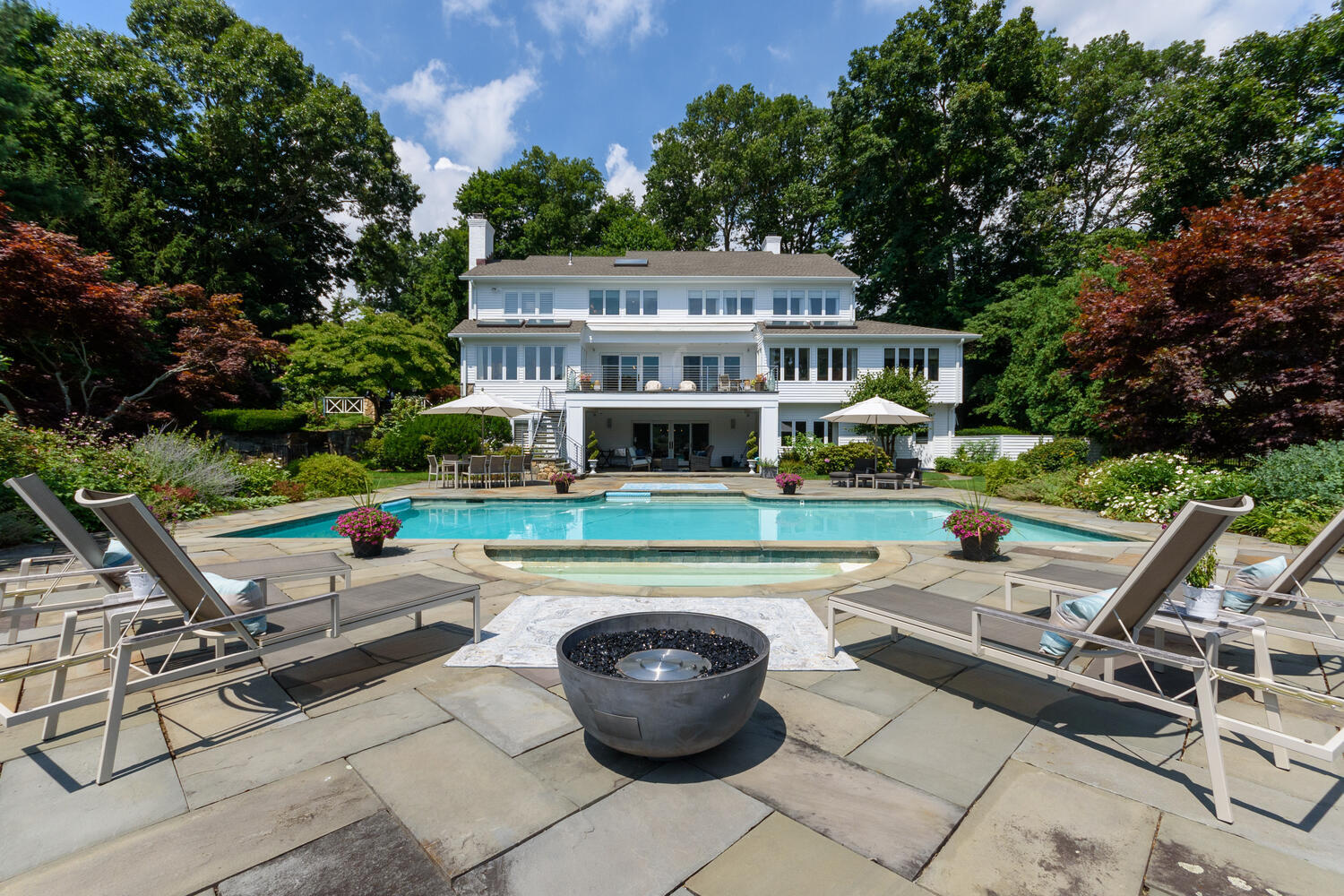 79 Rings End Road Darien, CT 06820 - Photo 37 of 42 a view of a white house couches chair and tables