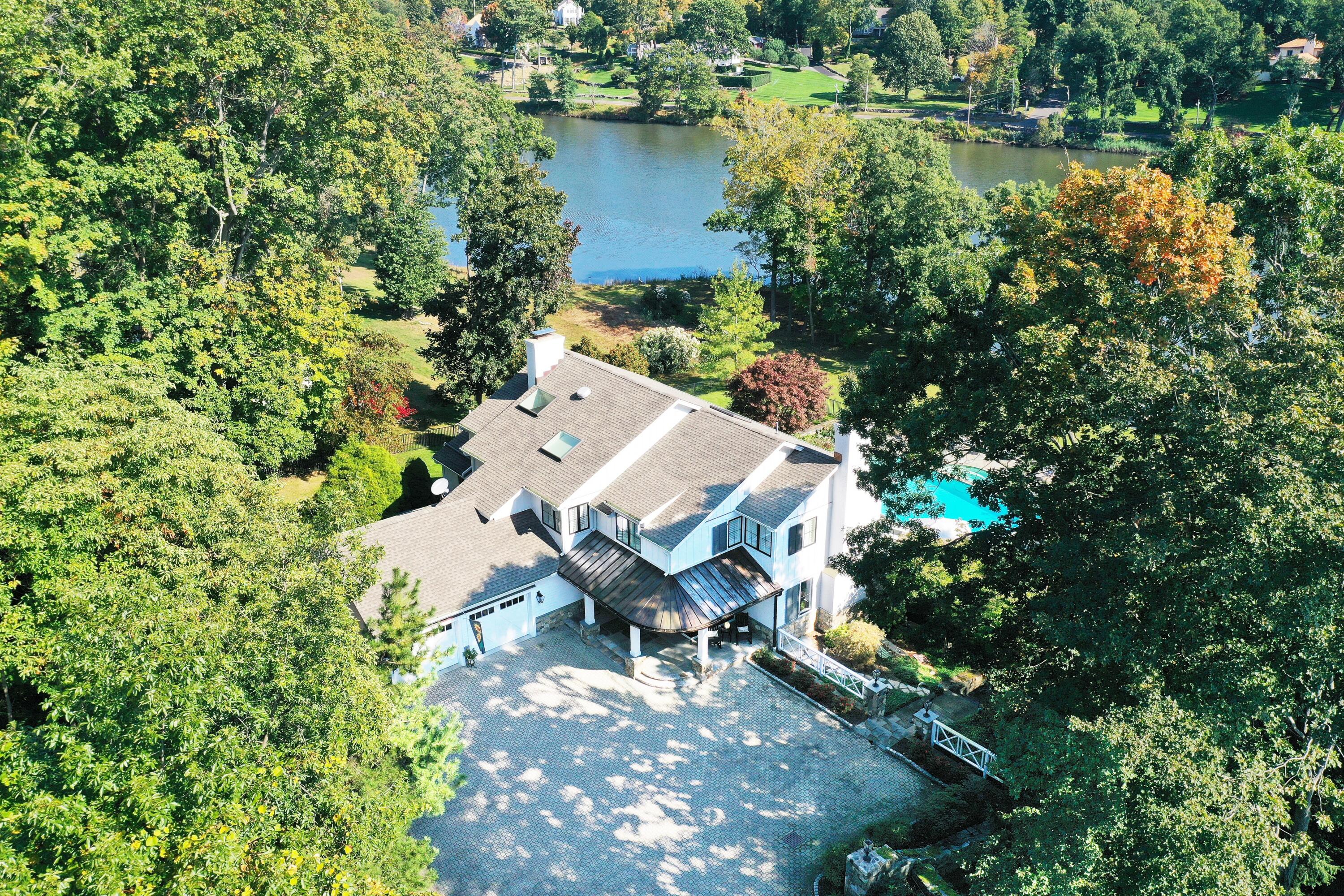 79 Rings End Road Darien, CT 06820 - Photo 4 of 42 an aerial view of a house with a yard and lake view
