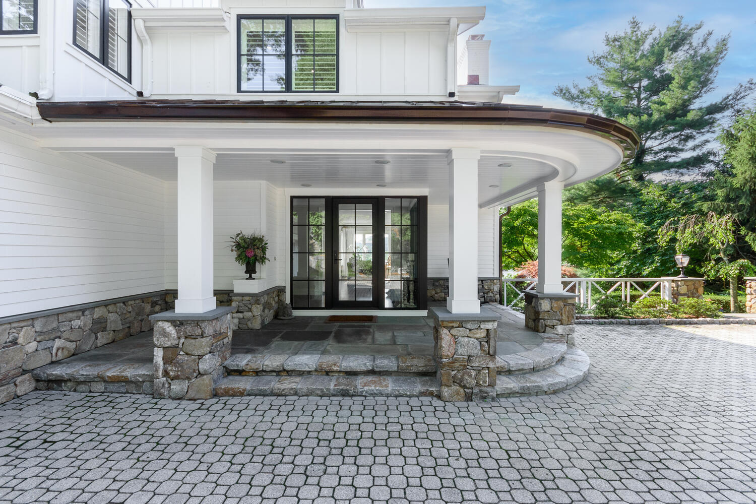 79 Rings End Road Darien, CT 06820 - Photo 8 of 42 a view of a patio with table and chairs and potted plants