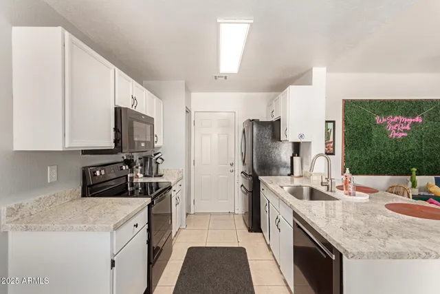 a kitchen with a sink stove and refrigerator
