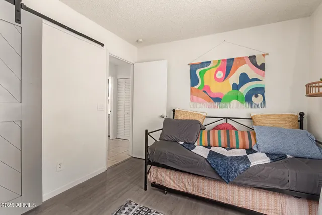 a living room with furniture and wall paintings