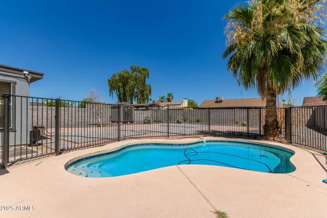 a view of a house with swimming pool and porch