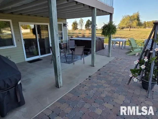 a view of a house with backyard sitting area and garden