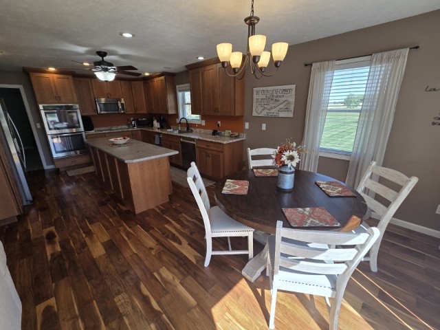 9251 Highway 148 Mount Vernon, IL 62864 - Photo 48 of 68 a view of a dining room with furniture a chandelier and wooden floor