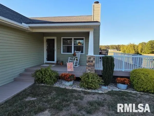 a kitchen with stainless steel appliances granite countertop a sink a stove a refrigerator a microwave oven with wooden floor and cabinets