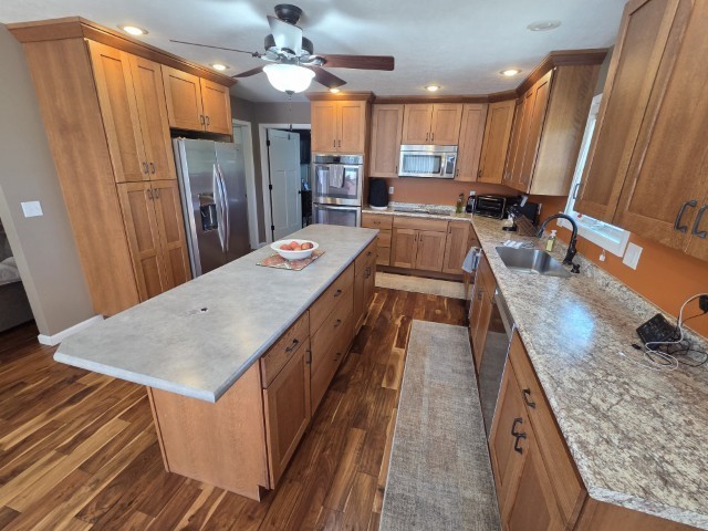 9251 Highway 148 Mount Vernon, IL 62864 - Photo 52 of 68 a kitchen with stainless steel appliances granite countertop a refrigerator a sink dishwasher a stove and white countertops with wooden floor