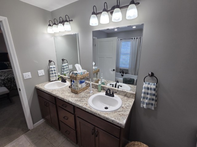 9251 Highway 148 Mount Vernon, IL 62864 - Photo 55 of 68 a bathroom with a granite countertop sink a light fixture and a mirror