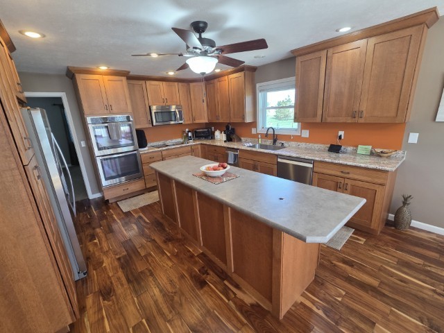9251 Highway 148 Mount Vernon, IL 62864 - Photo 6 of 68 a kitchen with stainless steel appliances granite countertop a refrigerator a sink dishwasher a stove and white countertops with wooden floor