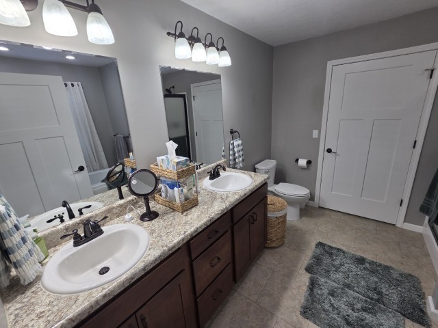 9251 Highway 148 Mount Vernon, IL 62864 - Photo 10 of 68 a bathroom with a double vanity sink and a mirror