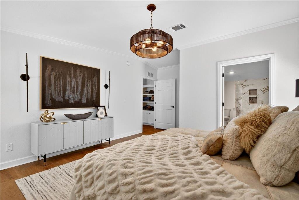 361 Coopers Cove Road St. Augustine, FL 32095 - Photo 17 of 35 a bedroom with a large bed and a chandelier