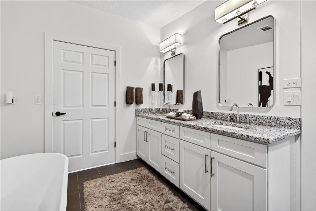 361 Coopers Cove Road St. Augustine, FL 32095 - Photo 20 of 35 a bathroom with a granite countertop sink and a mirror