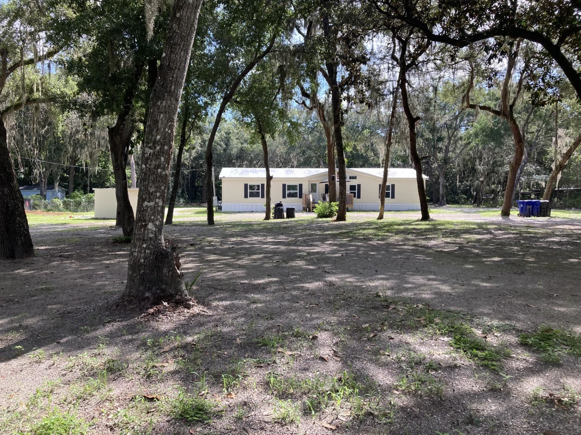 361 Coopers Cove Road St. Augustine, FL 32095 - Photo 2 of 35 a white house with trees in front of it