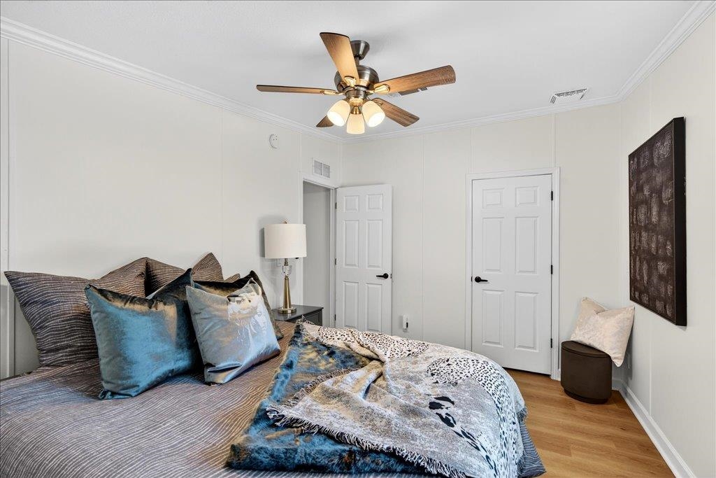 361 Coopers Cove Road St. Augustine, FL 32095 - Photo 24 of 35 a bedroom with a bed and wooden floor