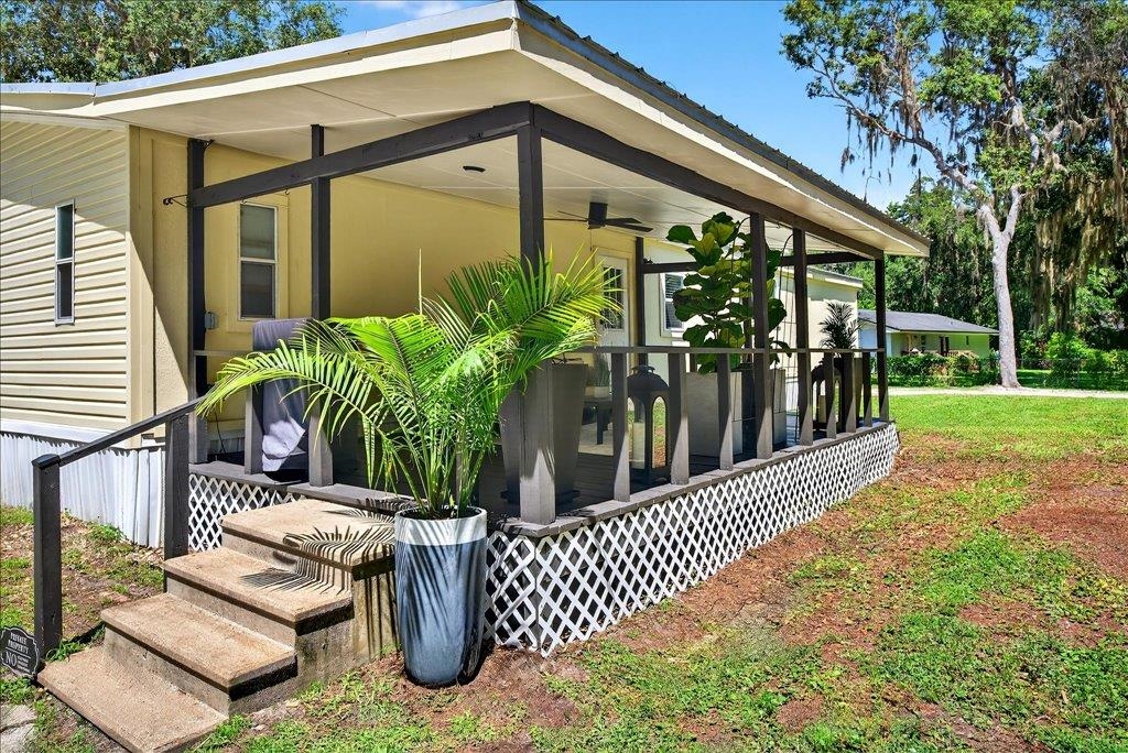 361 Coopers Cove Road St. Augustine, FL 32095 - Photo 29 of 35 a view of a porch with chairs and potted plants