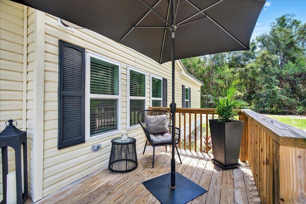 361 Coopers Cove Road St. Augustine, FL 32095 - Photo 31 of 35 a view of a deck with furniture and wooden floor