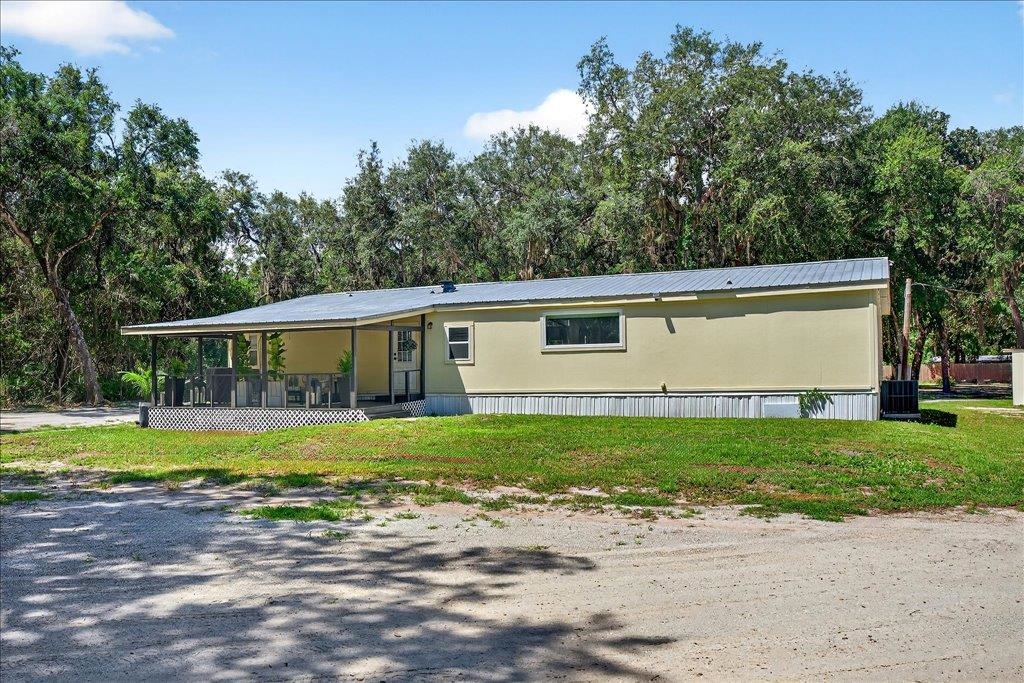 361 Coopers Cove Road St. Augustine, FL 32095 - Photo 33 of 35 a front view of a house with a yard and trees