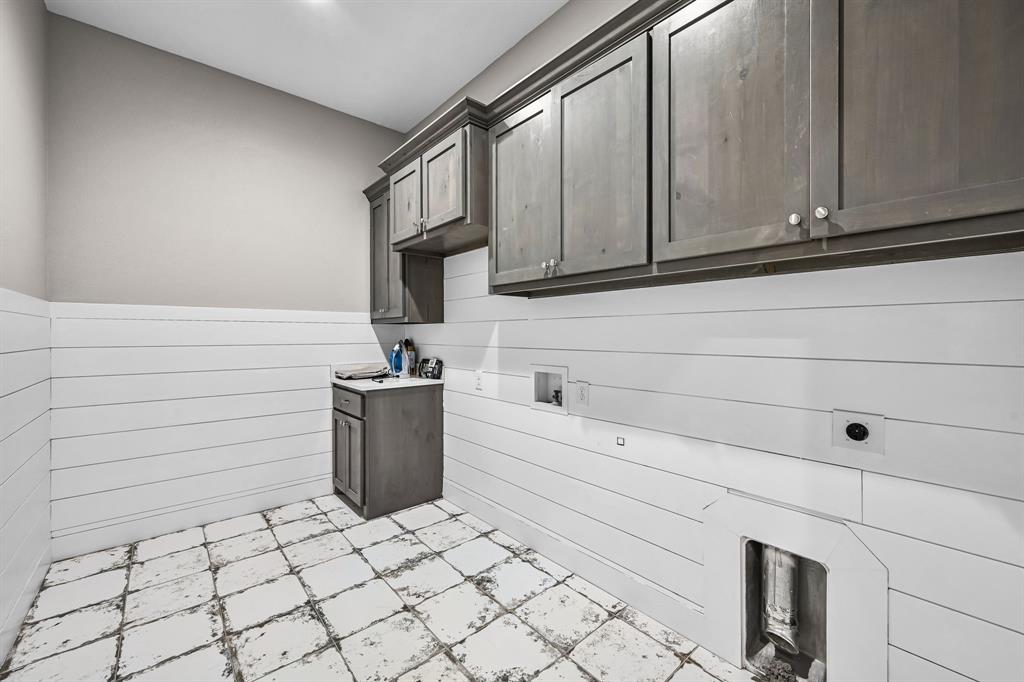1070 Cornelius Road Rockwall, TX 75087 - Photo 25 of 33 Laundry room featuring ample storage with upper and lower cabinetry including a sink