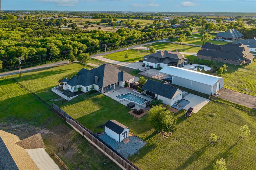 1070 Cornelius Road Rockwall, TX 75087 - Photo 32 of 33 Expansive property featuring a private swimming pool, concrete patio, detached garage, and a separate large metal outbuilding