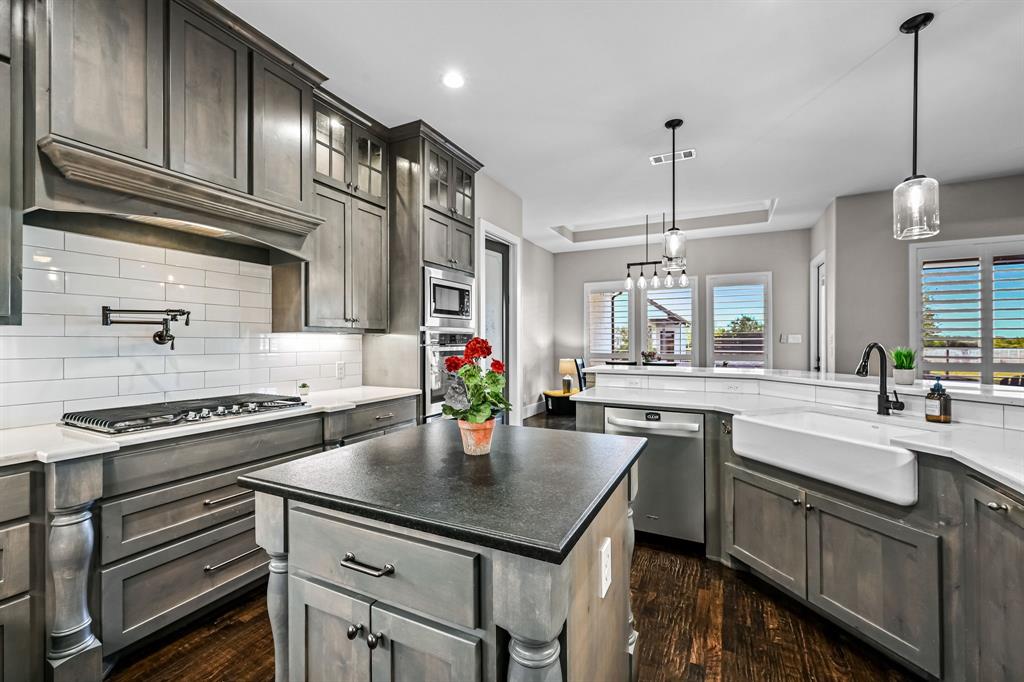 1070 Cornelius Road Rockwall, TX 75087 - Photo 10 of 33 Kitchen featuring a gas cooktop with a pot filler and a central island