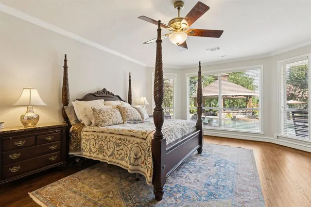 a bedroom with a bed chandelier and a window
