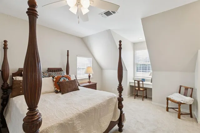 a bedroom with a bed a table and chair