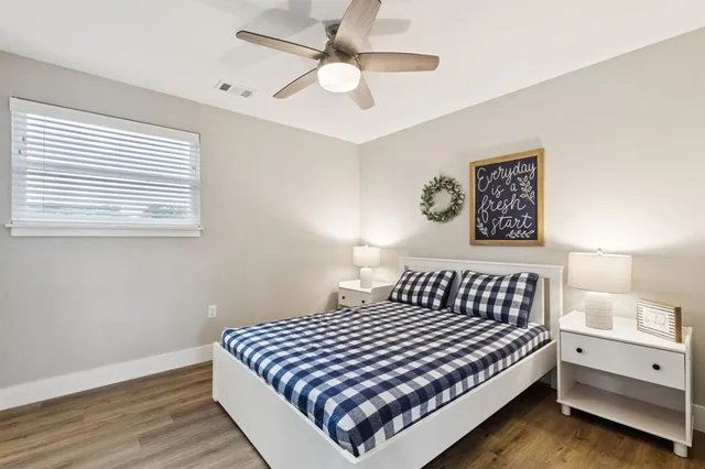 a bathroom with a granite countertop toilet sink and mirror