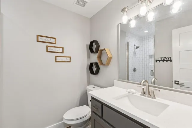 a bedroom with two beds and a lamp with wooden floor