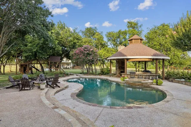 a view of a patio with couches table and chairs and a barbeque