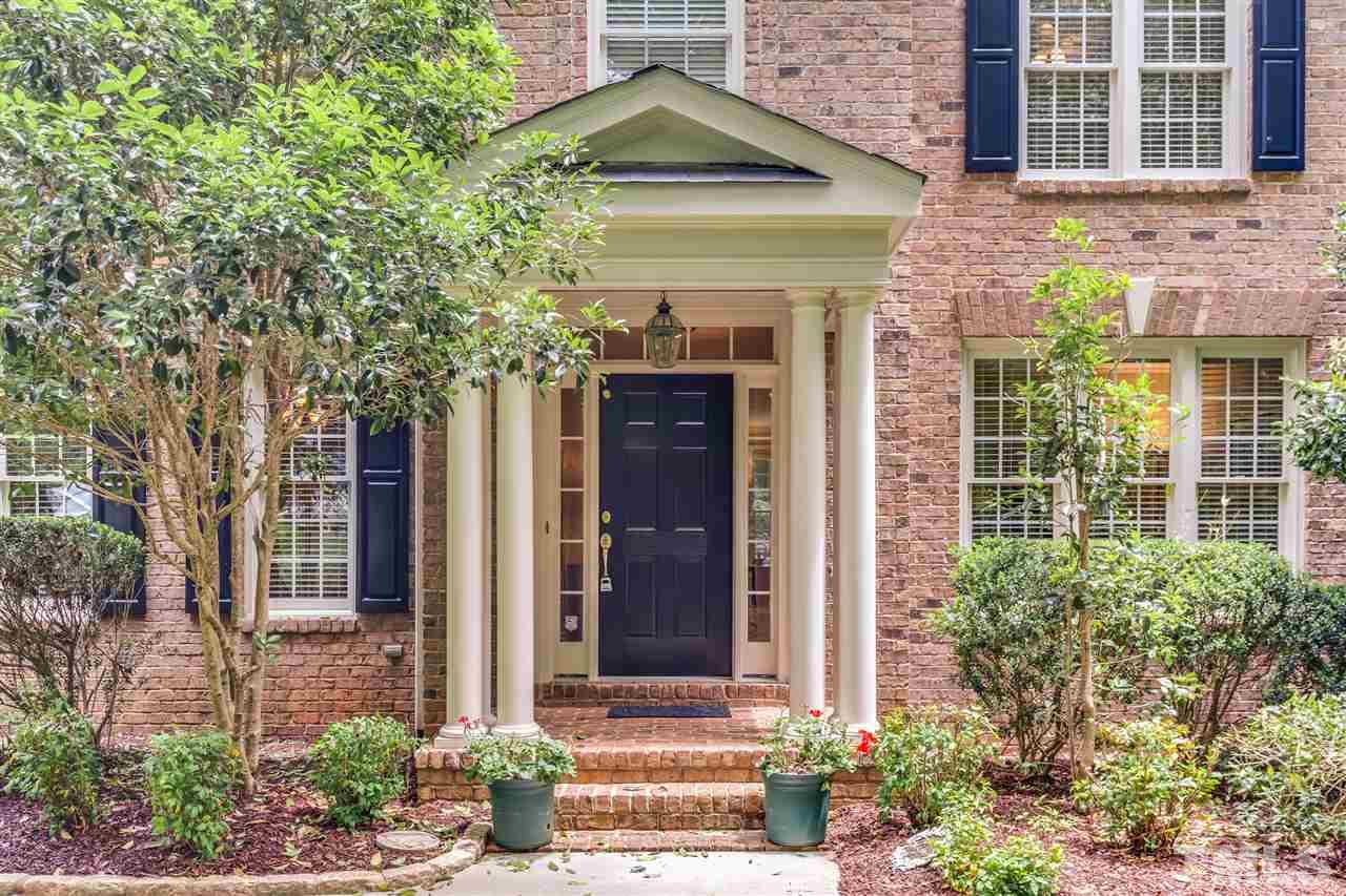 9428 Macon Road Raleigh, NC 27613 - Photo 2 of 25 a front view of a house with a garden
