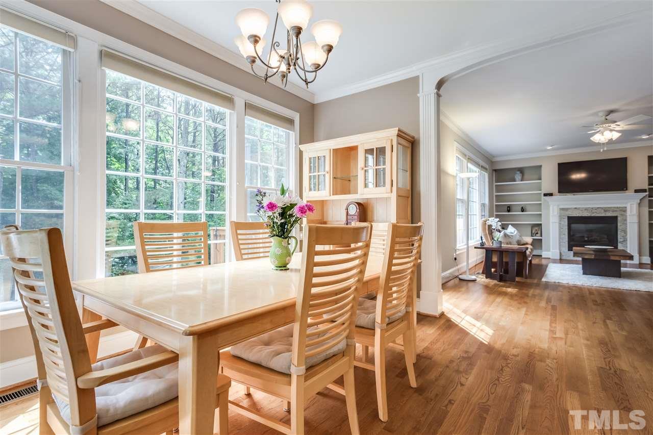 9428 Macon Road Raleigh, NC 27613 - Photo 13 of 25 a view of a dining room with furniture window and wooden floor