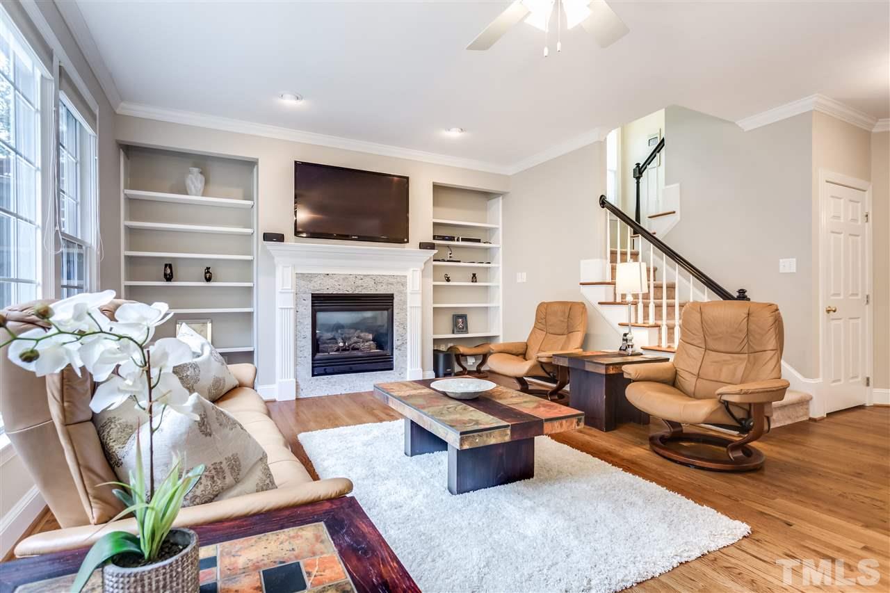9428 Macon Road Raleigh, NC 27613 - Photo 15 of 25 a living room with furniture fireplace and a flat screen tv