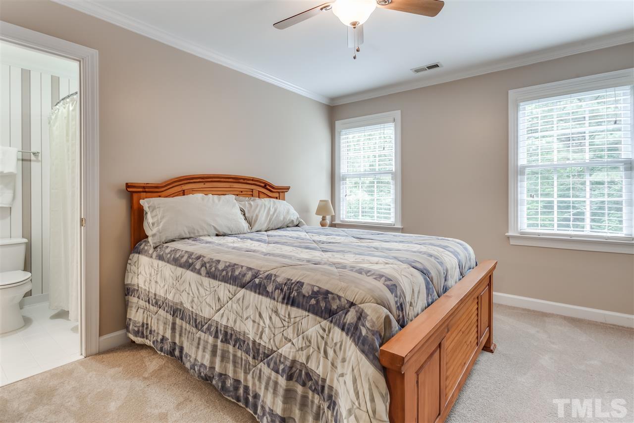 9428 Macon Road Raleigh, NC 27613 - Photo 21 of 25 a bedroom with a bed and a window