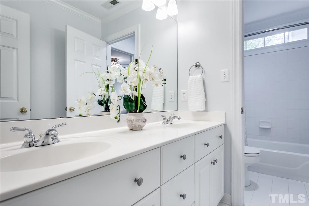 9428 Macon Road Raleigh, NC 27613 - Photo 22 of 25 a bathroom with a tub sink and mirror