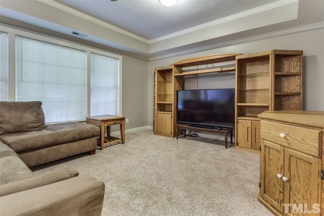 9428 Macon Road Raleigh, NC 27613 - Photo 23 of 25 a living room with furniture and a flat screen tv
