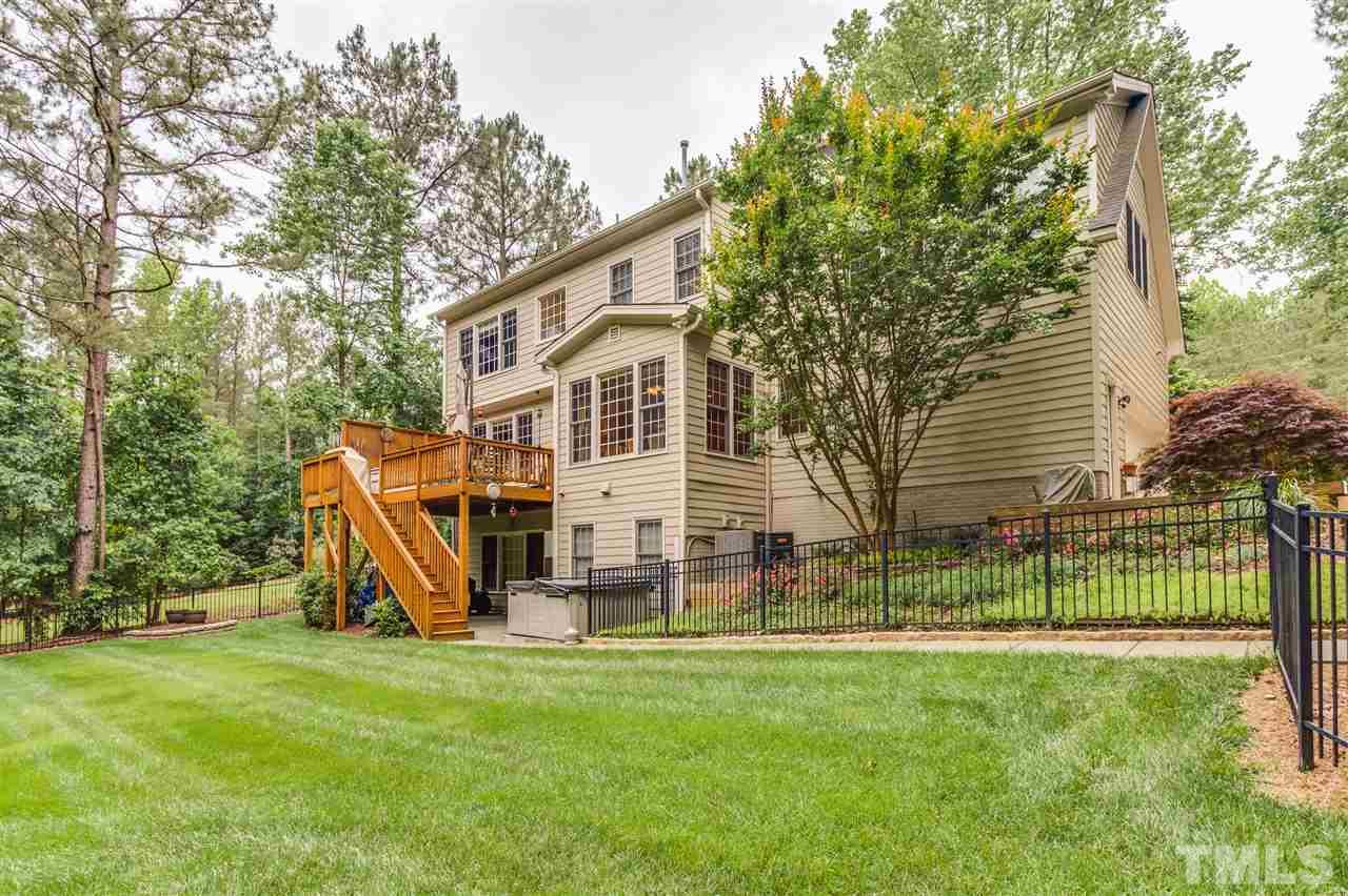 9428 Macon Road Raleigh, NC 27613 - Photo 6 of 25 a view of a house with a backyard and a tree