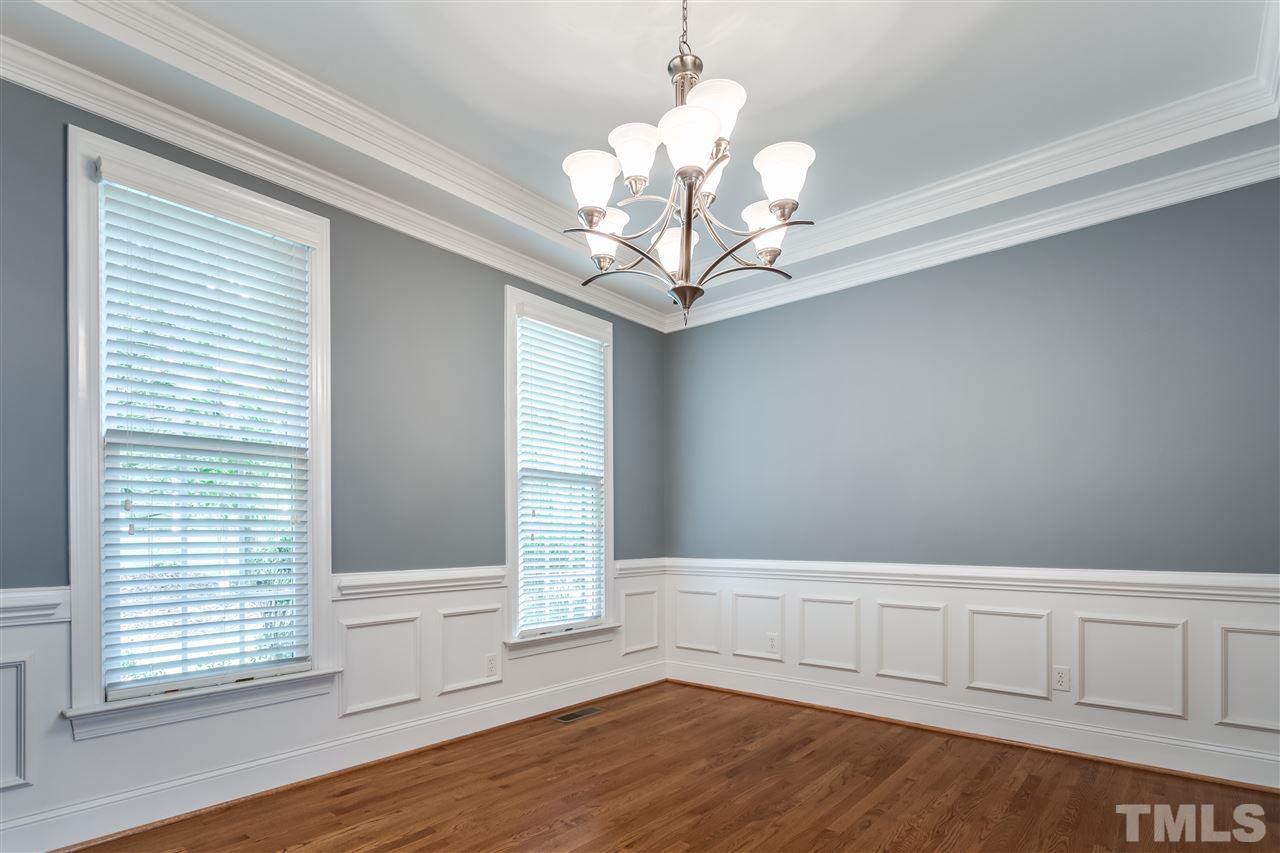9428 Macon Road Raleigh, NC 27613 - Photo 8 of 25 a view of an empty room with wooden floor and a window