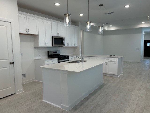 20811 Solaro Summit Trail Tomball, TX 77377 - Photo 4 of 19 a kitchen with kitchen island a sink stainless steel appliances and cabinets